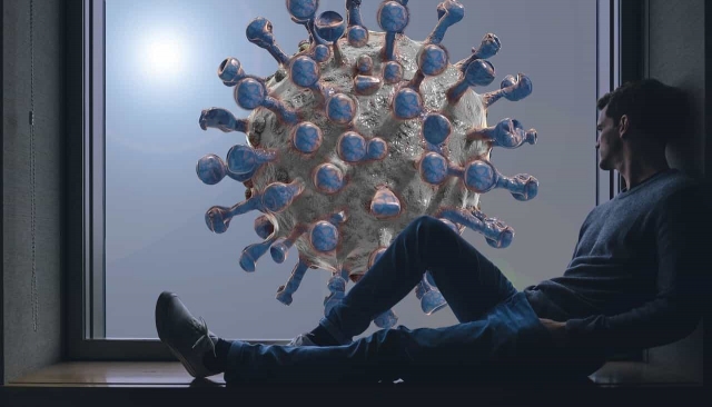 新型コロナウイルスの画像と座っている男性の画像
